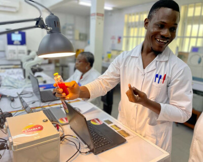 Hervé Kpoton, laboratory technician at CNHU-HKM, inspects a BactInsight blood culture bottle for signs of growth.