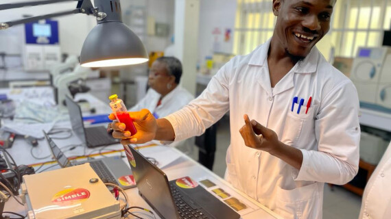 Hervé Kpoton, laboratory technician at CNHU-HKM, inspects a BactInsight blood culture bottle for signs of growth.